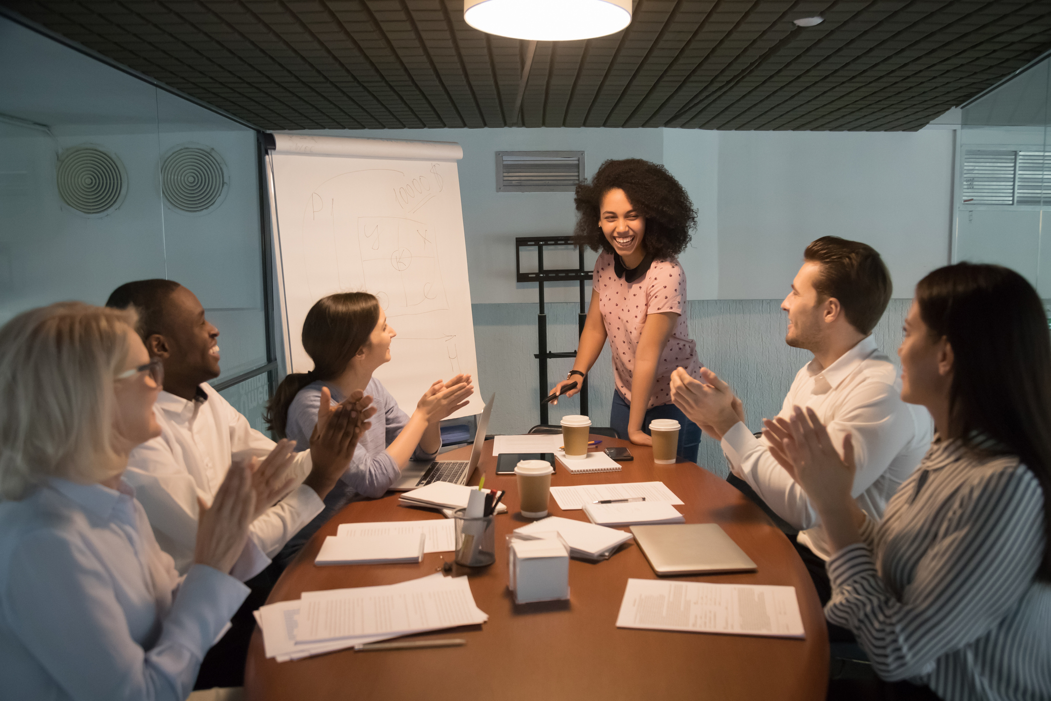 Visual depiction of a diverse group of professionals engaged in a meeting, showcasing individuals with various styles of visible piercings, emphasizing inclusivity and individuality in the workplace.